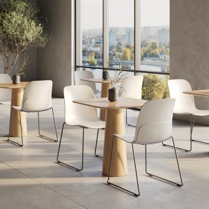 room with multiple tables and multiple white chair with metal frame